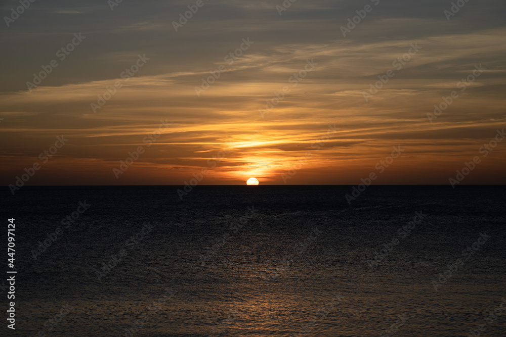 Sunset in Ibiza, sun goes down into the sea, Spain
