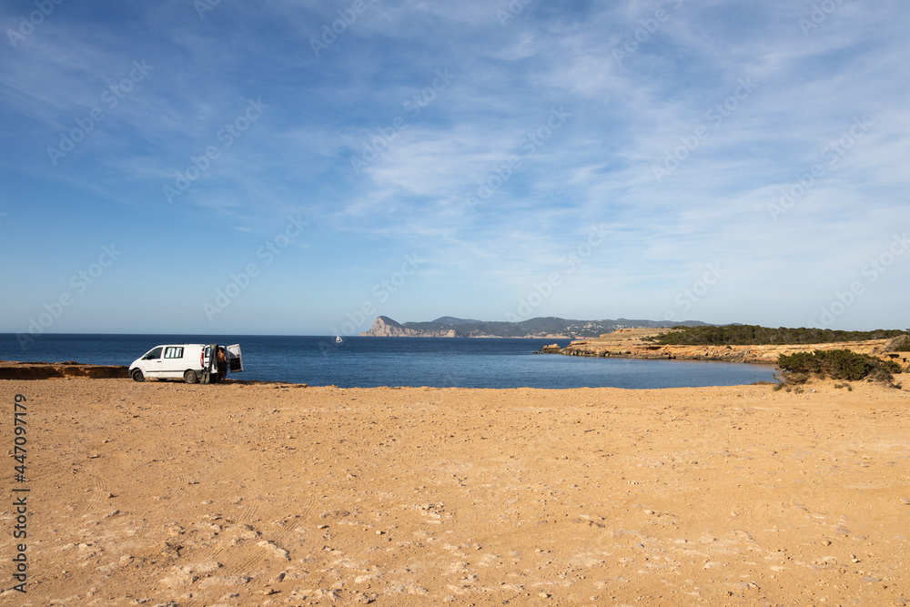 Cala roja in Ibiza, rocky seashore with crystal blue water, Spain