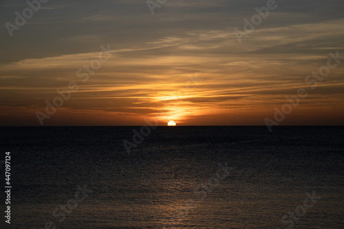Sunset in Ibiza, sun goes down into the sea, Spain
