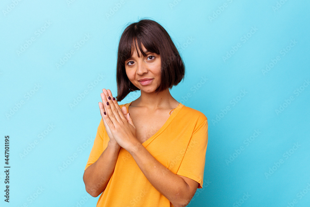Young mixed race woman isolated on blue background feeling energetic and comfortable, rubbing hands confident. Young mixed race woman isolated on blue background feeling energetic and comfortable, rubbing hands confident.
