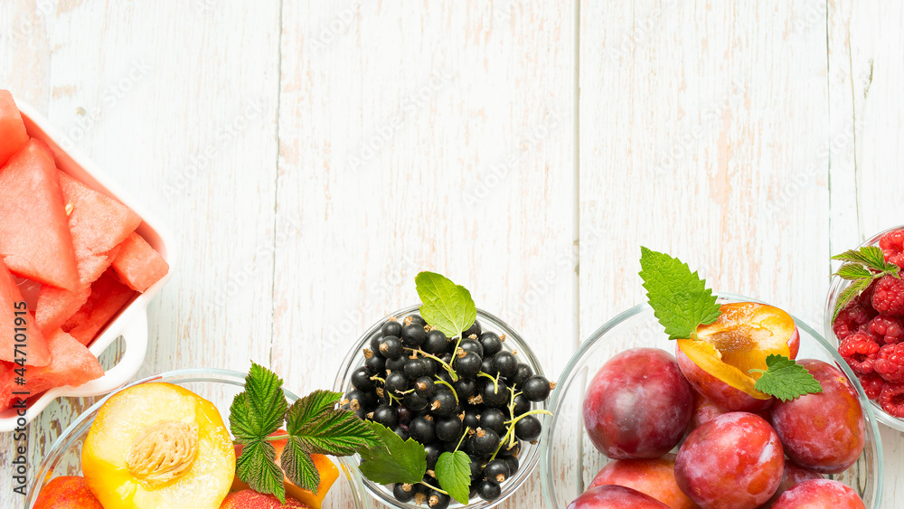 Variety of ripe summer fruits and berries on wooden background Variety of ripe summer fruits and berries on wooden background