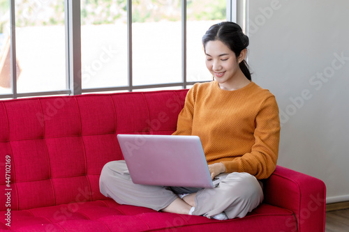 Social distancing concept: a business woman work at home with laptop