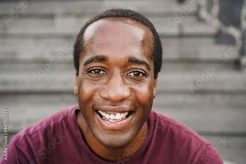 Photography African american man looking at camera outdoor in the city - Focus on face
