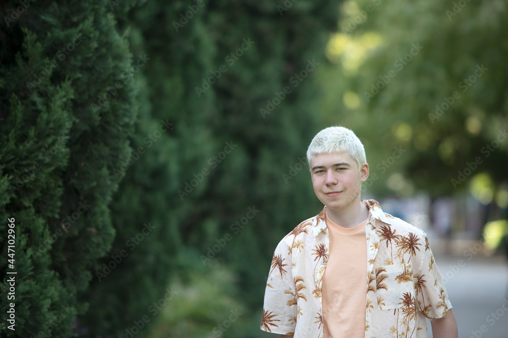 teenager in a place with trees looking at the camera teenager in a place with trees looking at the camera