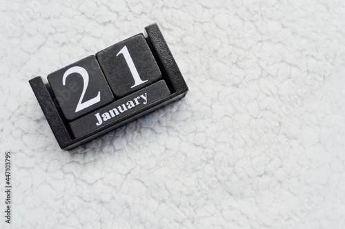 Wooden calendar from blocks on white background with copy space. 21st of January