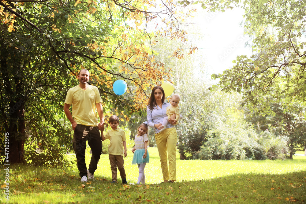 Obraz premium Family with children for a walk in the summer park. Сoming autumn&nbsp;in the park. Family. Fall. Happiness.