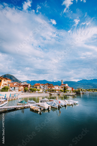 Feriolo, Verbania / Italy - June 2021: Feriolo village on Lake Maggiore with cloudy sky with small boats moored in the foreground
