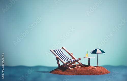 Valokuva Still life shot of an island with an umbrella,one sunbed, a table and a drink on it