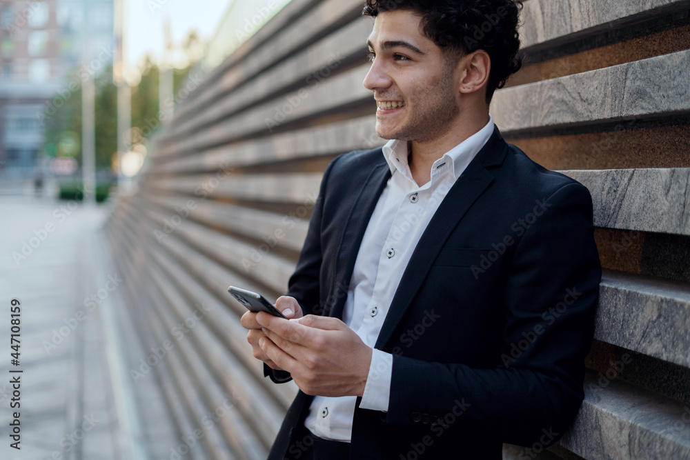 The lawyer communicates via SMS via phone with the client. A business man is dressed in a stylish jacket. The manager is a successful Caucasian-looking stylish man with gray hair. The lawyer communicates via SMS via phone with the client. A business man is dressed in a stylish jacket. The manager is a successful Caucasian-looking stylish man with gray hair.