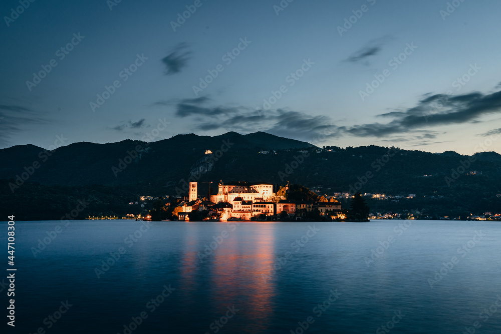 Orta San Giulio / Italy - June 2021: The island of San Giulio at sunset (blue hour), long exposure