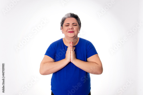 people diversity young lady with white hair joins hands in prayer, cheering and praying wearing blue on white background
