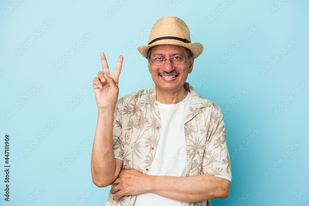 Senior indian man wearing summer clothes isolated on blue background Senior indian woman wearing a african costume isolated on white background showing number two with fingers. Senior indian man wearing summer clothes isolated on blue background Senior indian woman wearing a african costume isolated on white background showing number two with fingers.