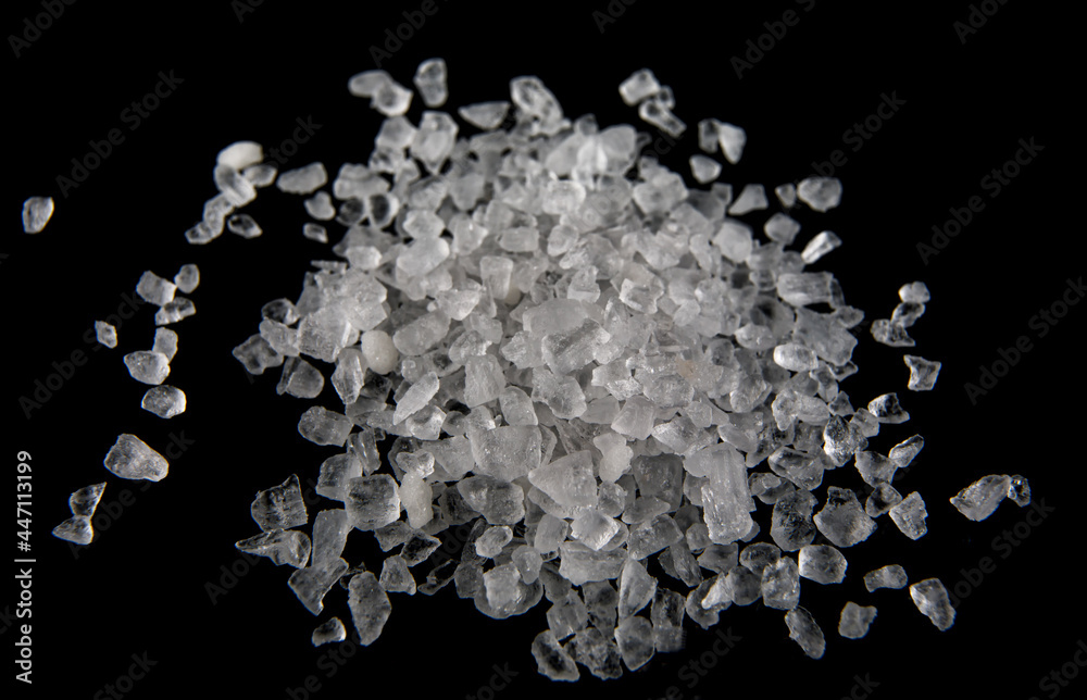 Crystals of white sea salt isolated on black background. Crystals of white sea salt isolated on black background.