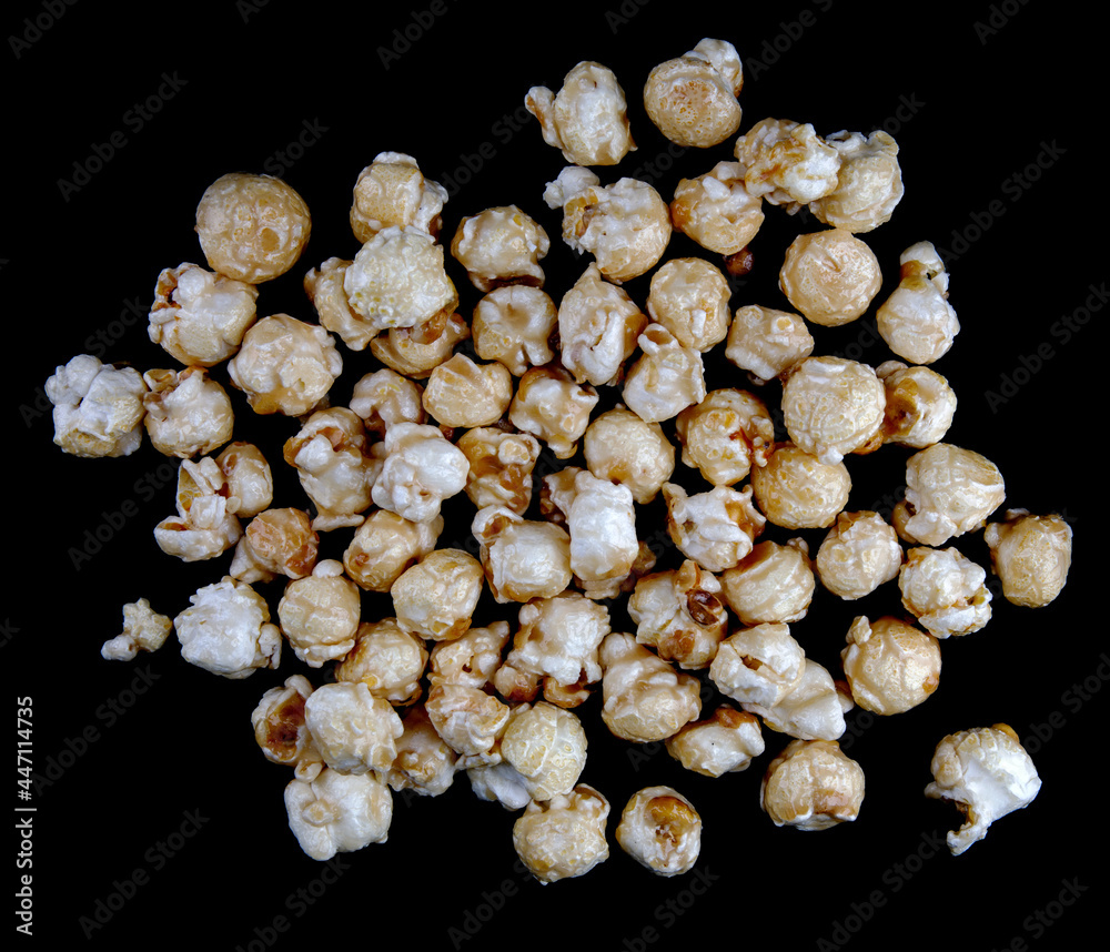 Popcorn is scattered on a black background. Popcorn background. Popcorn is scattered on a black background. Popcorn background.