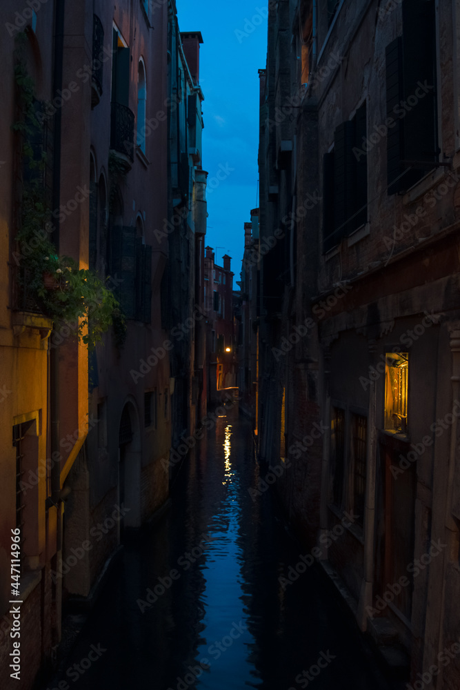 beautif narrow water canal at the blue hour in Venice Italy
