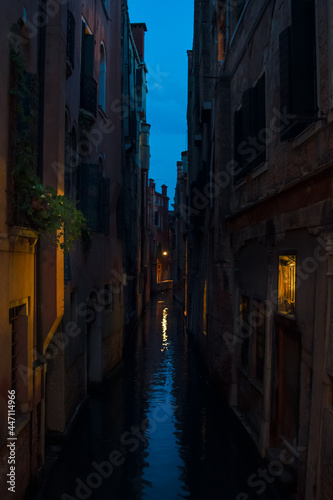 beautif narrow water canal at the blue hour in Venice Italy