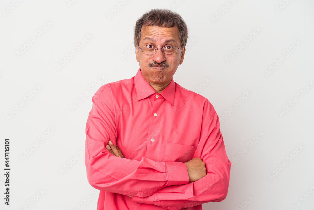 Middle aged indian man isolated on white background blows cheeks, has tired expression. Facial expression concept. Middle aged indian man isolated on white background blows cheeks, has tired expression. Facial expression concept.