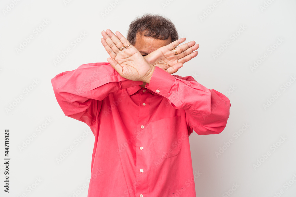 Middle aged indian man isolated on white background keeping two arms crossed, denial concept. Middle aged indian man isolated on white background keeping two arms crossed, denial concept.