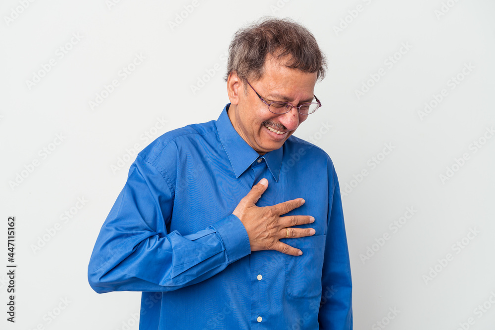 Middle aged indian man isolated on white background laughing keeping hands on heart, concept of happiness. Middle aged indian man isolated on white background laughing keeping hands on heart, concept of happiness.