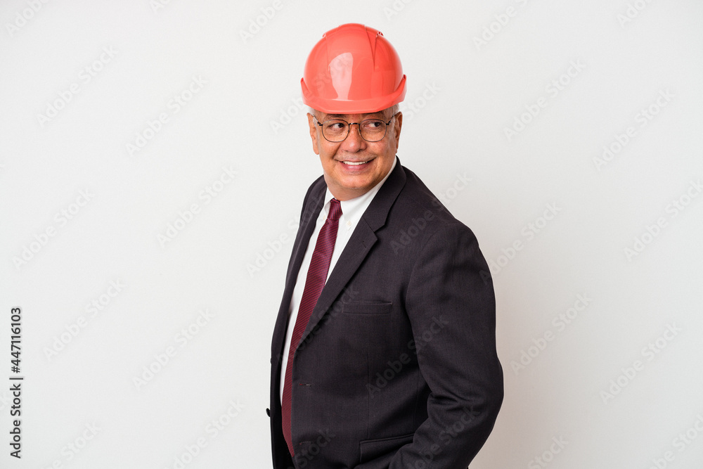 Senior american arquitech man isolated on white background looks aside smiling, cheerful and pleasant. Senior american arquitech man isolated on white background looks aside smiling, cheerful and pleasant.