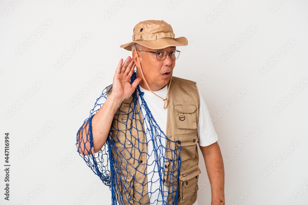 Senior american fisherman holding net isolated on white background trying to listening a gossip. Senior american fisherman holding net isolated on white background trying to listening a gossip.