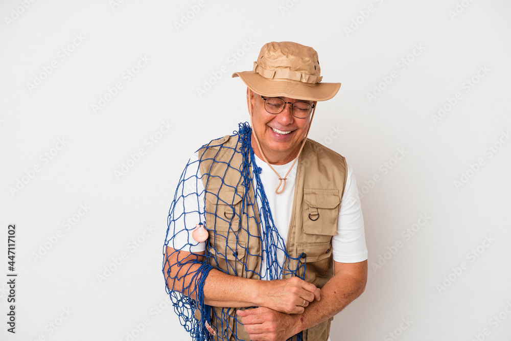 Senior american fisherman holding net isolated on white background laughing and having fun. Senior american fisherman holding net isolated on white background laughing and having fun.