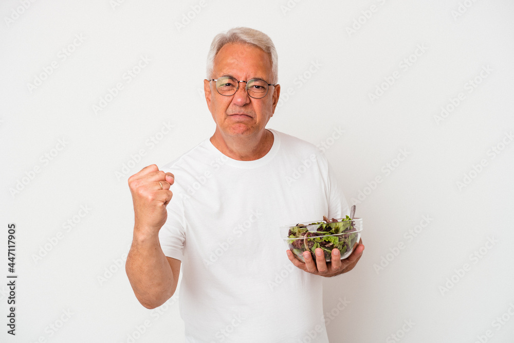 custom made wallpaper toronto digitalSenior american man eating salad isolated on white background showing fist to camera, aggressive facial expression.
