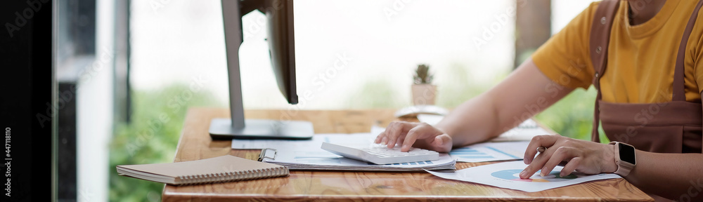Fototapeta premium female finance accountant making working audit and calculating expense financial annual report balance sheet statement, Internal Revenue Service Inspector Checking Document Audit Concept