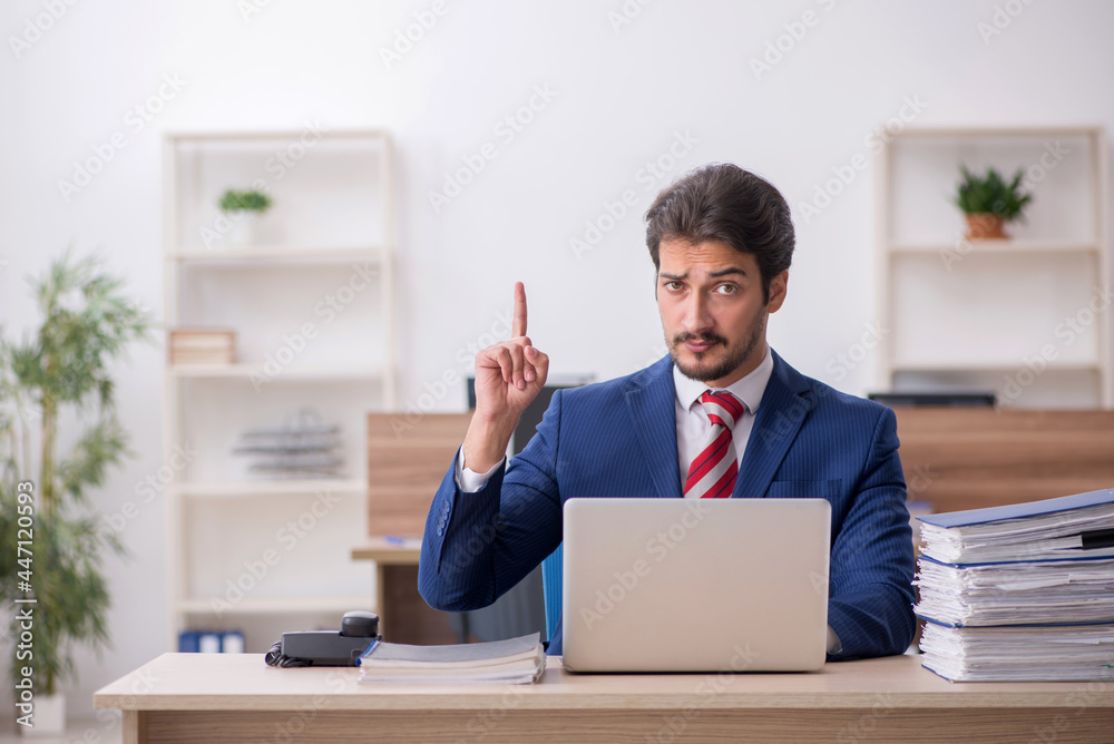 Young male employee working in the office Young male employee working in the office