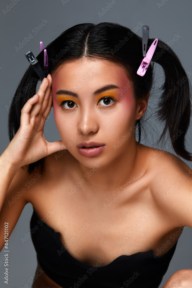 Portrait of a beautiful asian girl, large portred girl with thick hair gathered in two hfostik, beauty concept