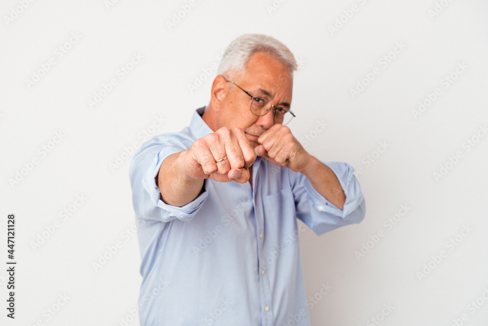 Senior american man isolated on white background throwing a punch, anger, fighting due to an argument, boxing. Senior american man isolated on white background throwing a punch, anger, fighting due to an argument, boxing.