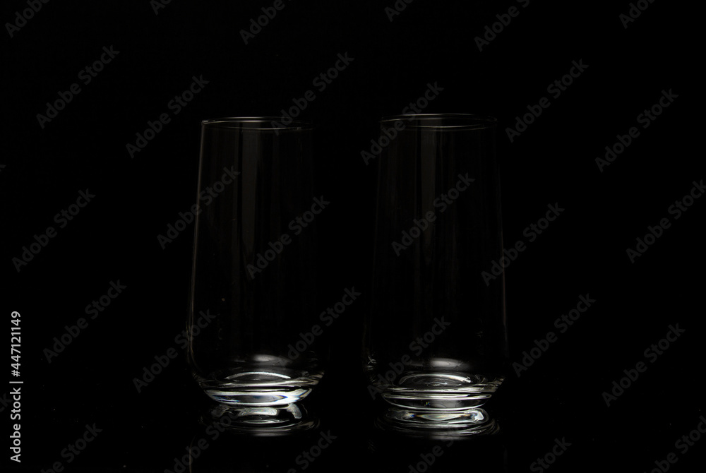 Two empty glasses for wine in a dark studio environment Two empty glasses for wine in a dark studio environment