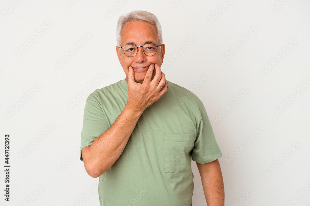 Senior american man isolated on white background doubting between two options.