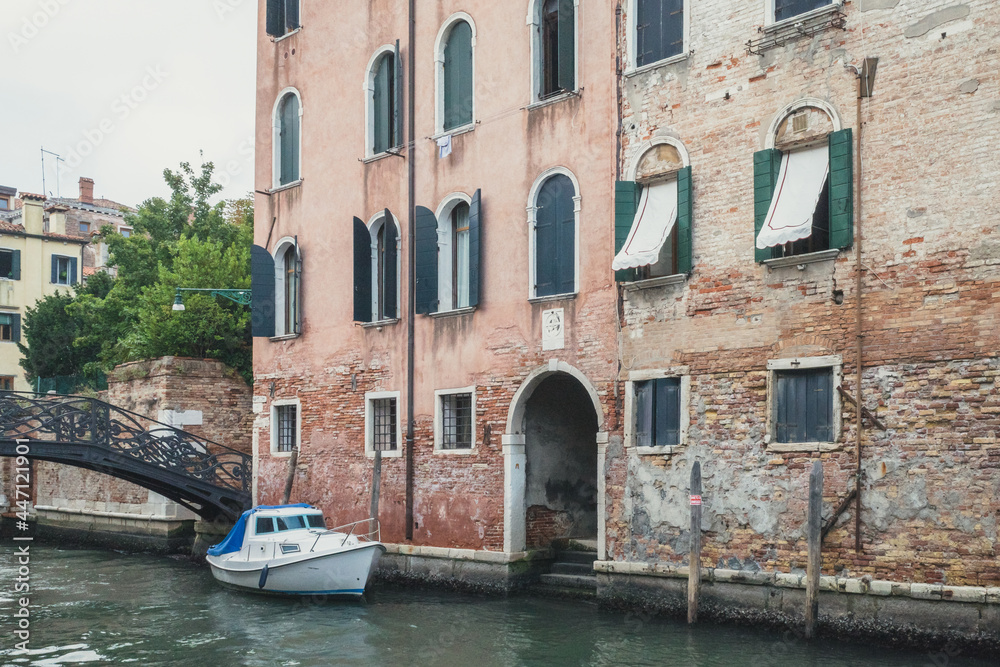 Narrow canal by traditional Venetian house, Venice, Italy Narrow canal by traditional Venetian house, Venice, Italy