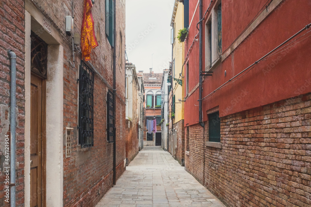 Narrow alley between traditional Venetian houses, Venice, Italy Narrow alley between traditional Venetian houses, Venice, Italy