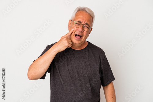 Senior american man isolated on white background crying, unhappy with something, agony and confusion concept.