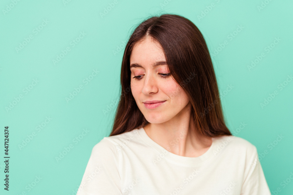 Young caucasian woman isolated on blue background Young caucasian woman isolated on blue background