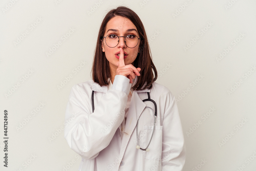 Young doctor caucasian woman isolated on white background keeping a secret or asking for silence. Young doctor caucasian woman isolated on white background keeping a secret or asking for silence.
