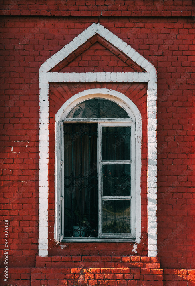 old window in a church building, red brick wall old window in a church building, red brick wall