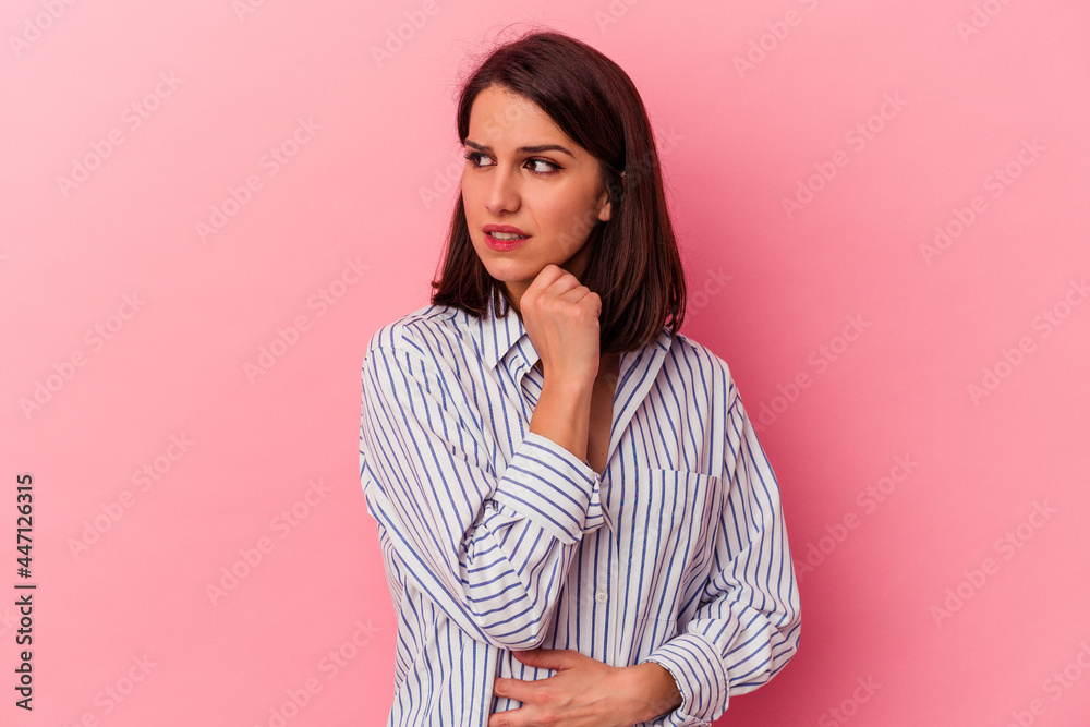 Fototapeta premium Young caucasian woman isolated on pink background suffers pain in throat due a virus or infection.