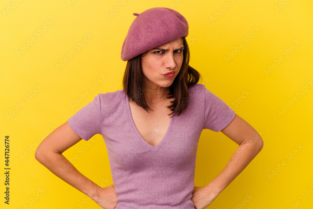 Young caucasian woman isolated on yellow background blows cheeks, has tired expression. Facial expression concept. Young caucasian woman isolated on yellow background blows cheeks, has tired expression. Facial expression concept.