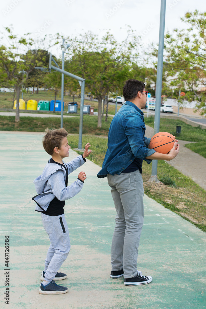 Stylish young boy, teenager is playing with ball, outdoors Stylish young boy, teenager is playing with ball, outdoors