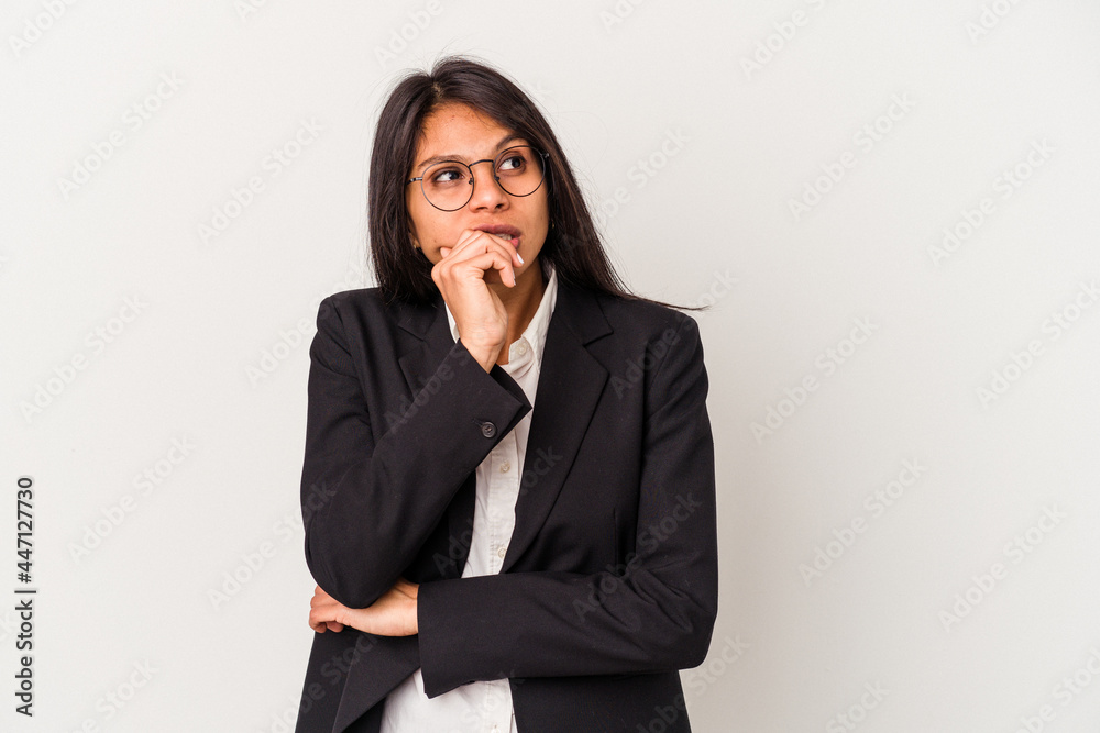 Young business latin woman isolated on white background relaxed thinking about something looking at a copy space. Young business latin woman isolated on white background relaxed thinking about something looking at a copy space.
