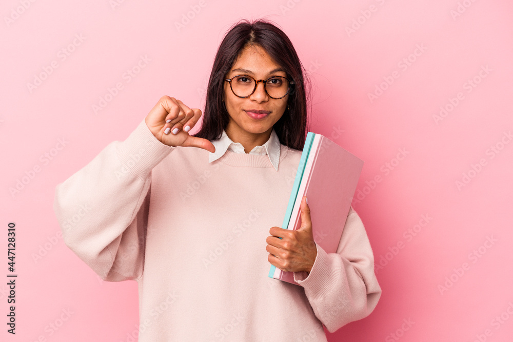 Young student latin woman isolated on pink background feels proud and self confident, example to follow. Young student latin woman isolated on pink background feels proud and self confident, example to follow.