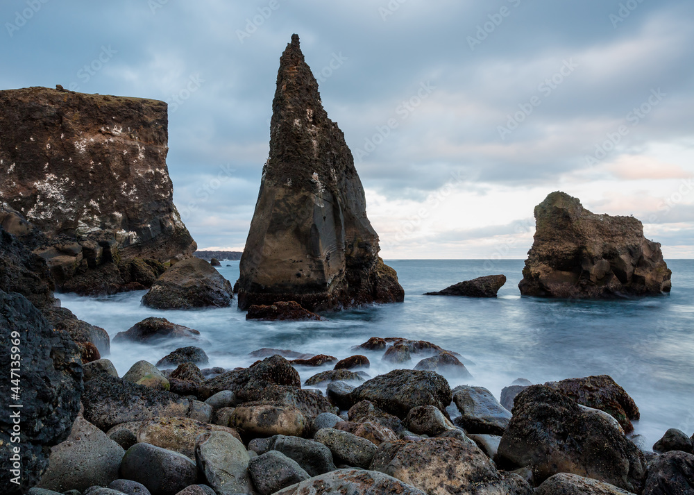 Icelandic wild coast with large rocks on the beach