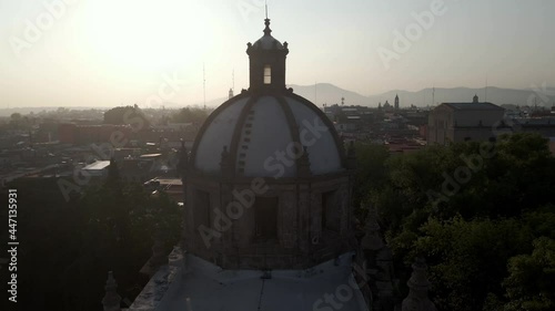 silhouette of church in city at sunrise