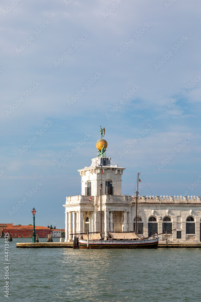 Atlas statues dogana di mare customs house at grand canal in venice italy. 17th century atlases hold globe with weathervane on top.