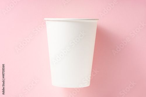 White paper cup on a pink background. Top view.Ecology concept