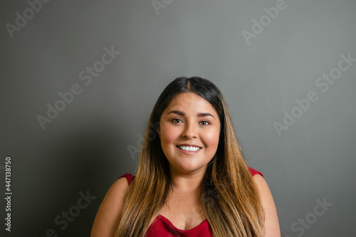 portrait of beautiful overweight mexican woman smiling. young hispanic