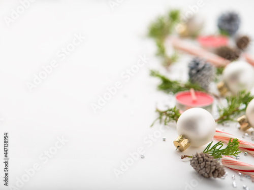 Christmas. New Year. Creative handmade composition of cones, Christmas tree branches, candles. Blurred background. White background. Pastel shades.